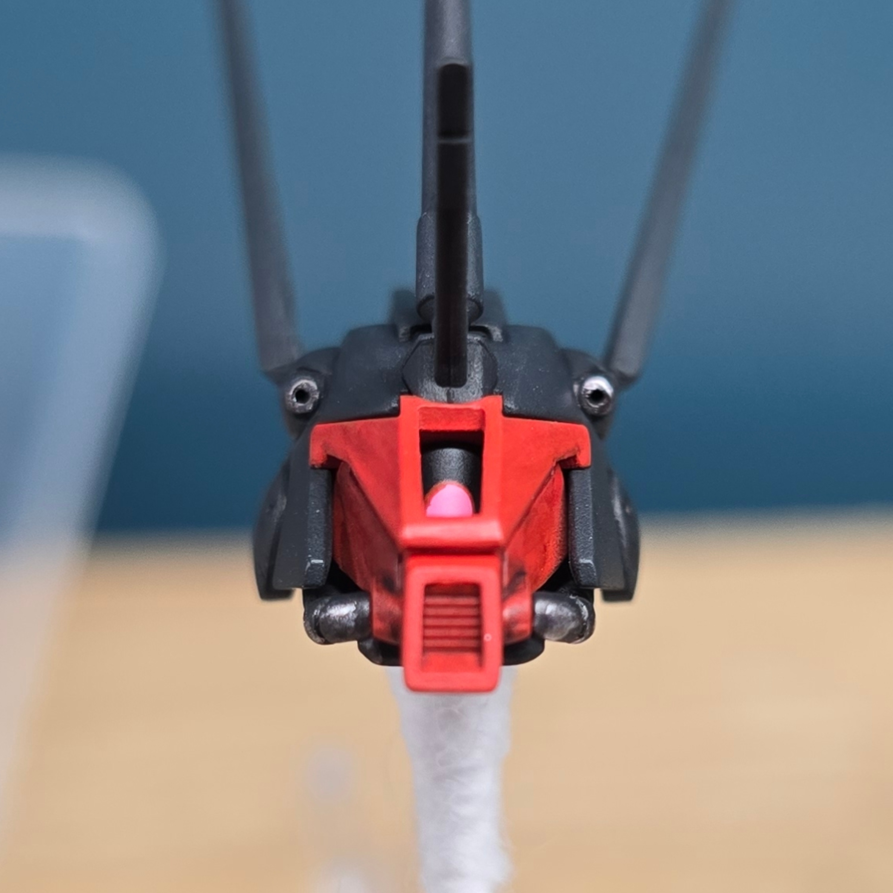 Gundam head close-up, red and black with twin antennas